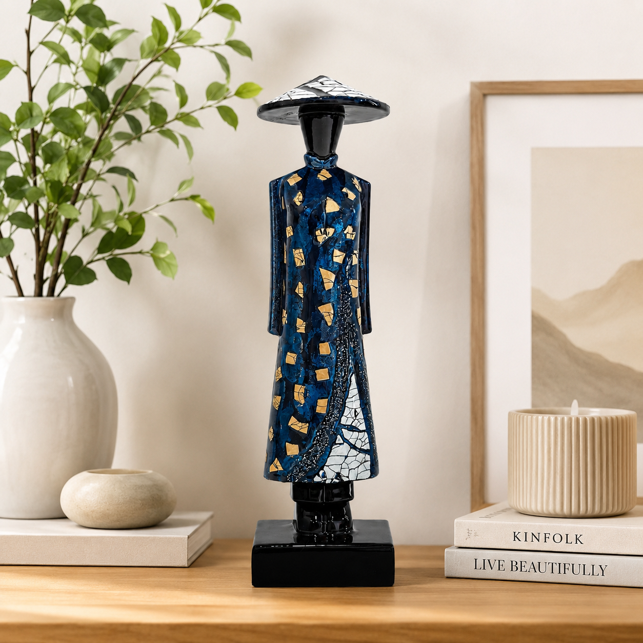 Vietnamese lacquer Ao Dai lady statue displayed on a modern bookshelf as home decor.